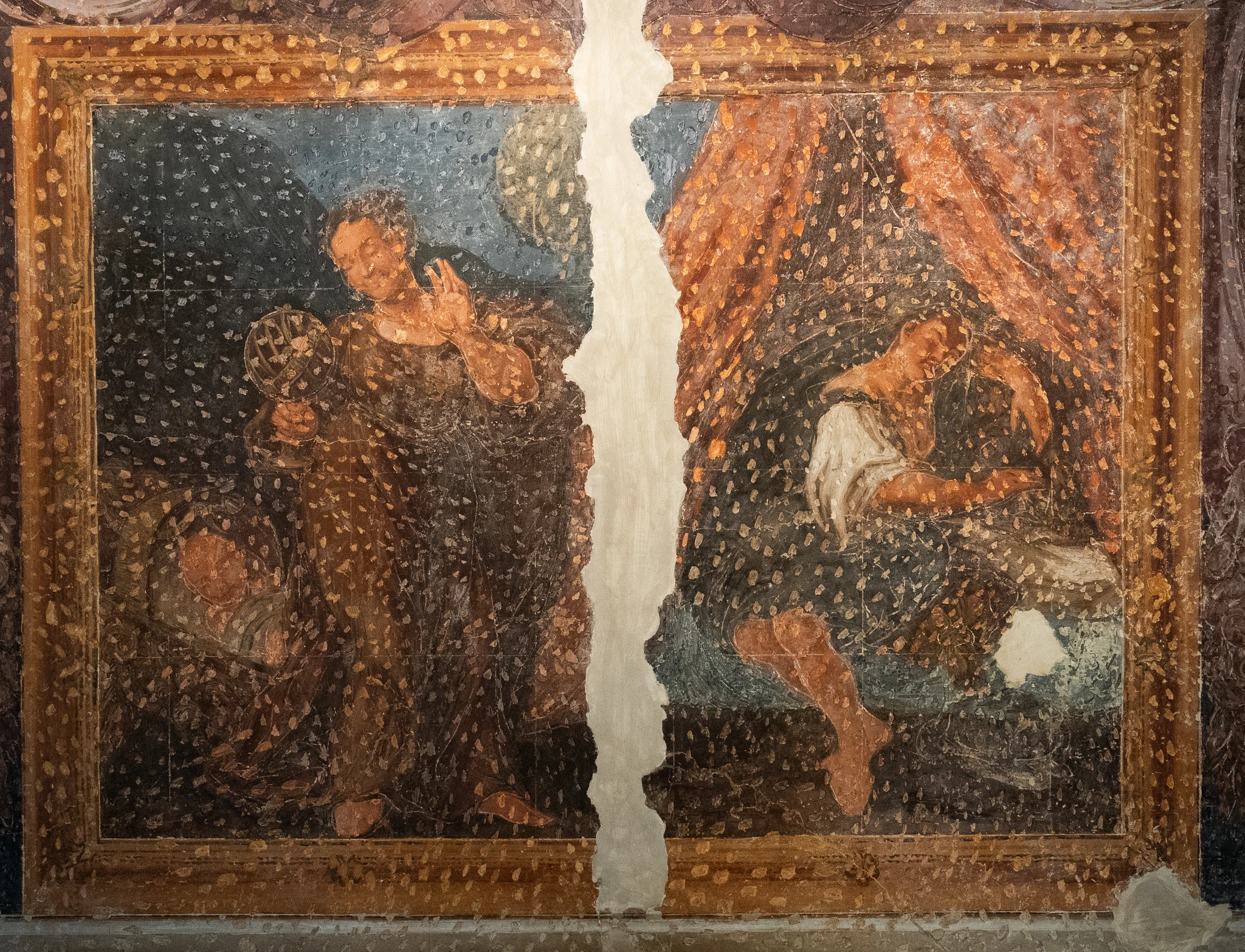 Affresco antico diviso verticalmente da una larga lacuna centrale. A sinistra si vede una figura vestita con abiti scuri all’interno di una cornice decorata; a destra un’altra figura è seduta o reclinata sotto un tendaggio decorato. La superficie dell’opera presenta diffuse zone di degrado e perdita di colore.